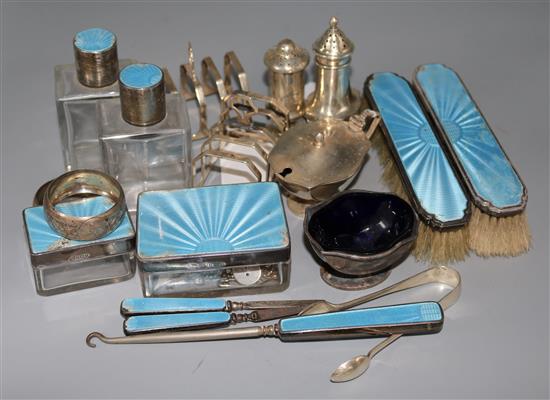 A pair of 1930s silver toastracks and sixteen other items of silver including dressing table set and napkin rings.